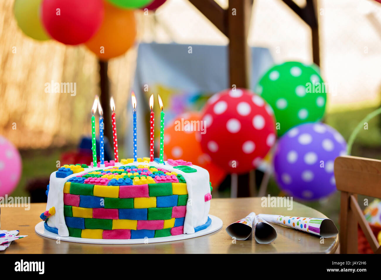 Colorful cake with candles and balloons for a child party Stock Photo