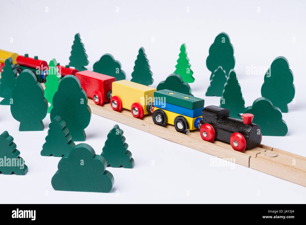fast train driving through small forest. scenery made of wooden toy Stock Photo