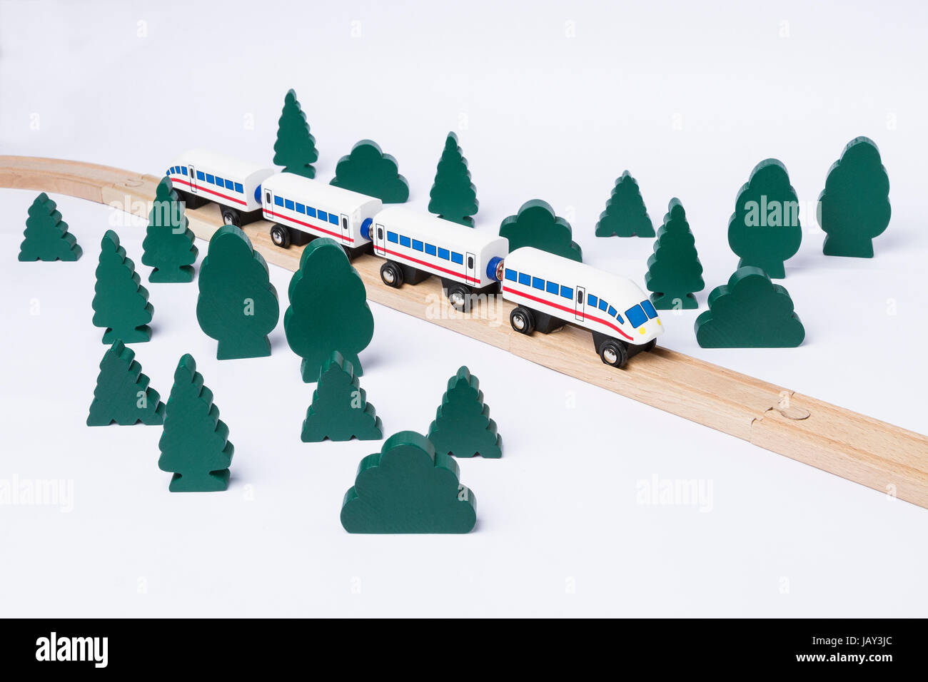 fast train driving through small forest. scenery made of wooden toy Stock Photo
