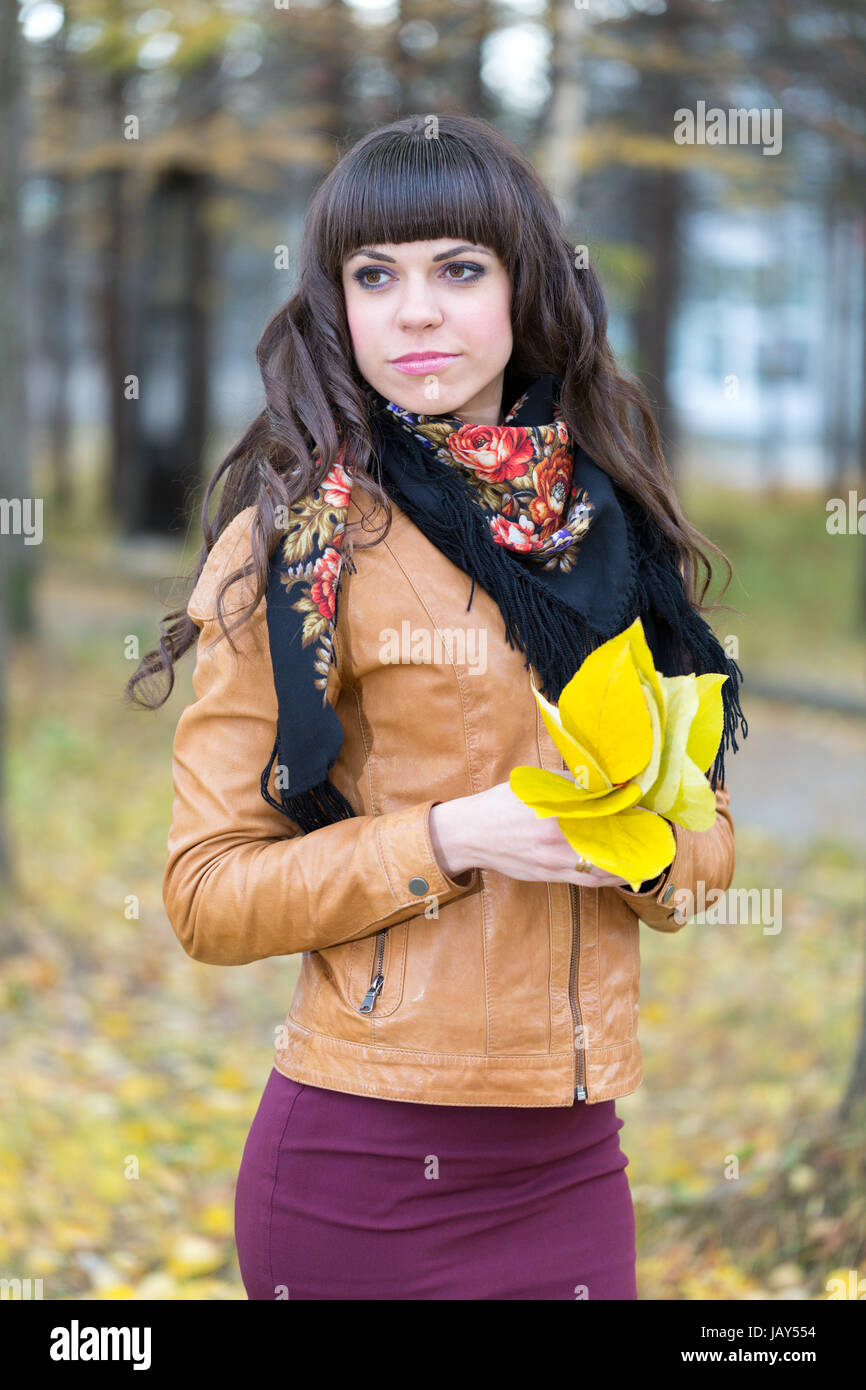Portrait of a beautiful girl in the autumn forest with yellow leaves in ...