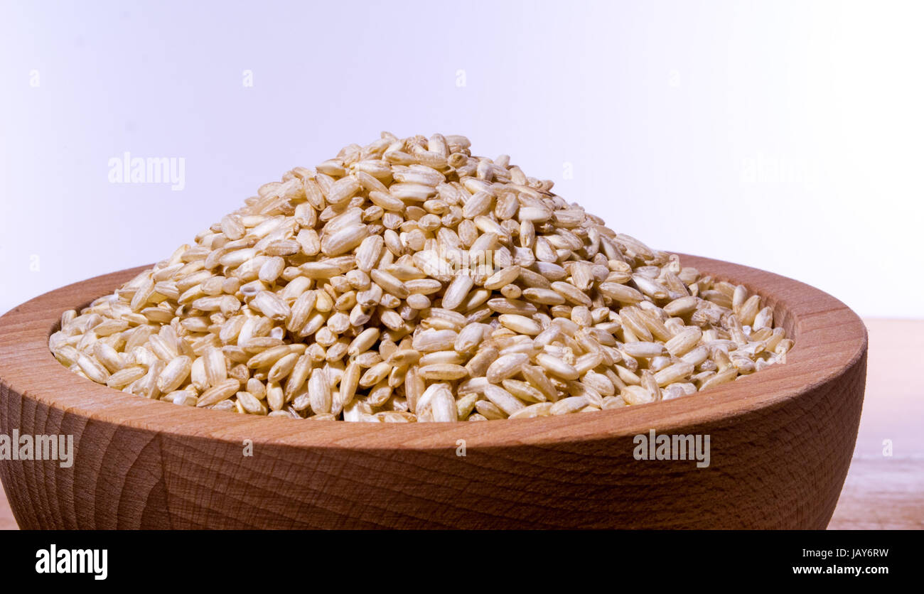 wooden bowl filled with grains of rice Stock Photo Alamy