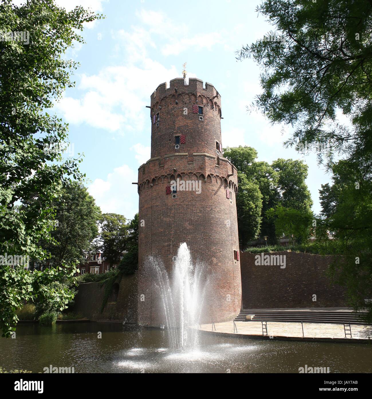 Kronenburgerpark in centre of Nijmegen, Netherlands, with 30m high Kruittoren (1426), part of the former medieval city ramparts (stitch of 2 images). Stock Photo