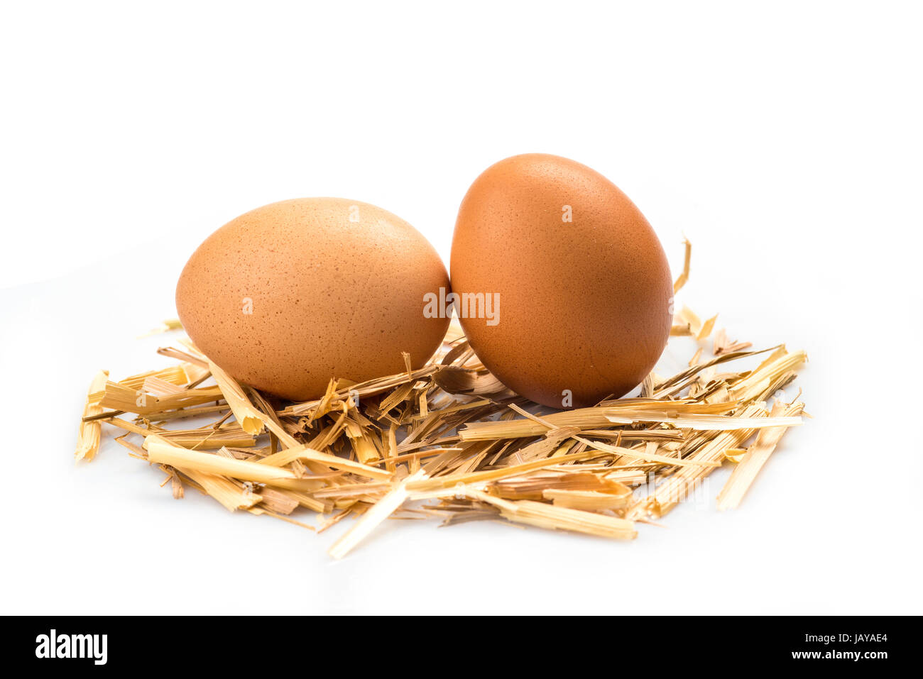 Fresh eggs on some straw isolated over a white background Stock Photo ...