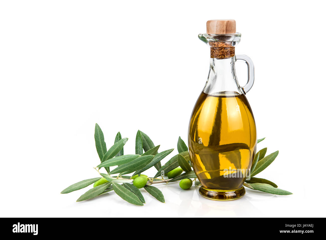 Olive oil in a glass bottle and green olives isolated over a white ...