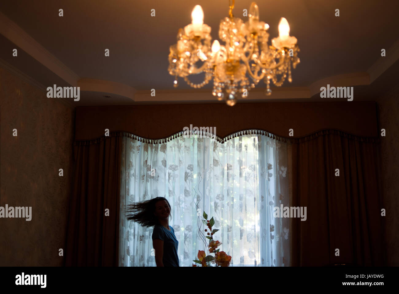 Silhouette of a girl near the window Stock Photo