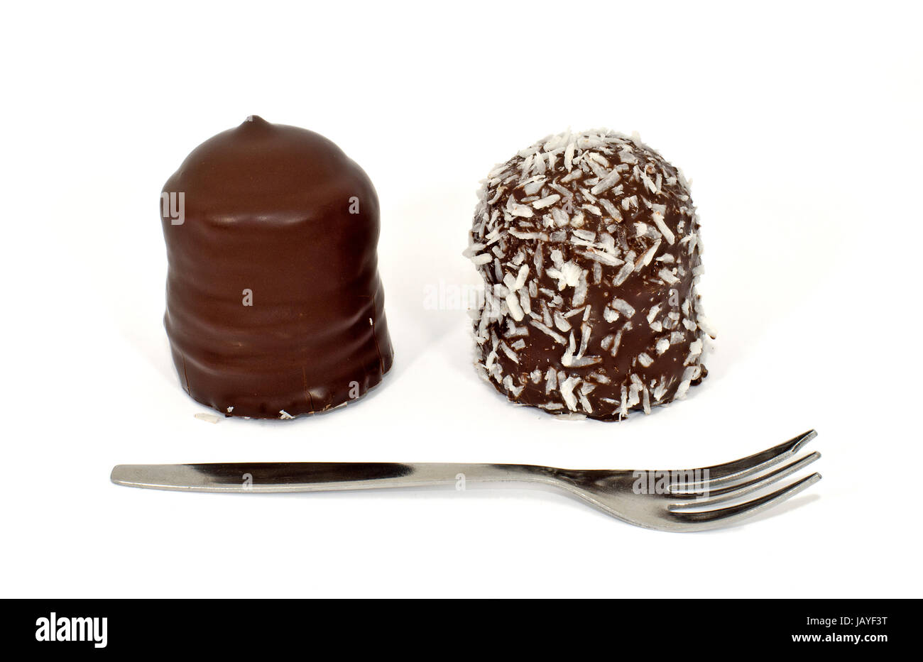 Zwei Schokoküsse mit Gabel; two chocolate covered marshmallow treats and a small fork Stock Photo