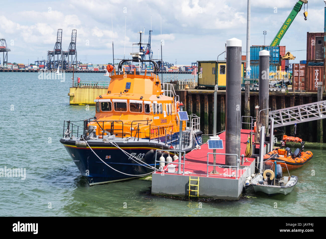 RNLB 'Albert Brown', Severn class Harwich lifeboat, and Felixstowe container port, Harwich Essex England Stock Photo