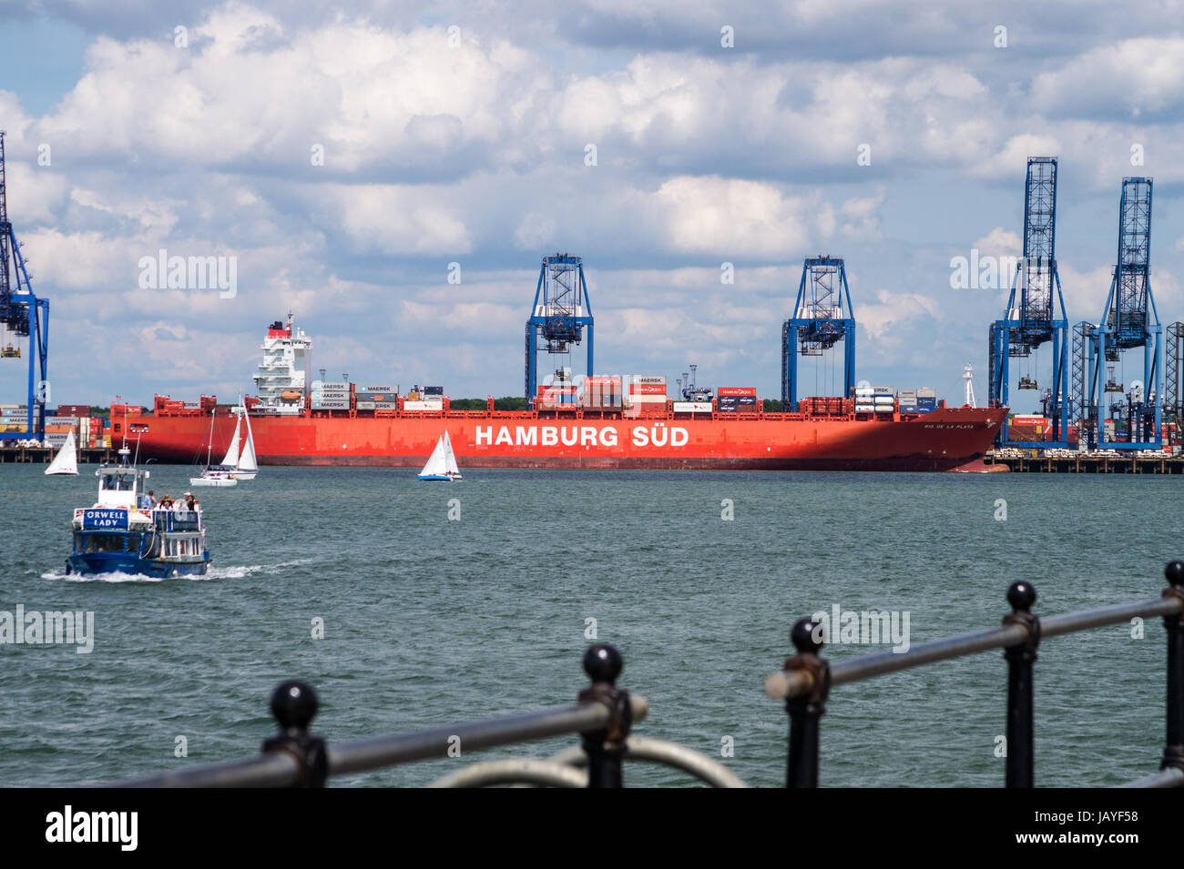 'Orwell Lady' sightseeing cruise boat, and Felixstowe container port, seen from Harwich Essex. Behind, Hamburg Sud container ship 'Rio de la Plata'. Stock Photo