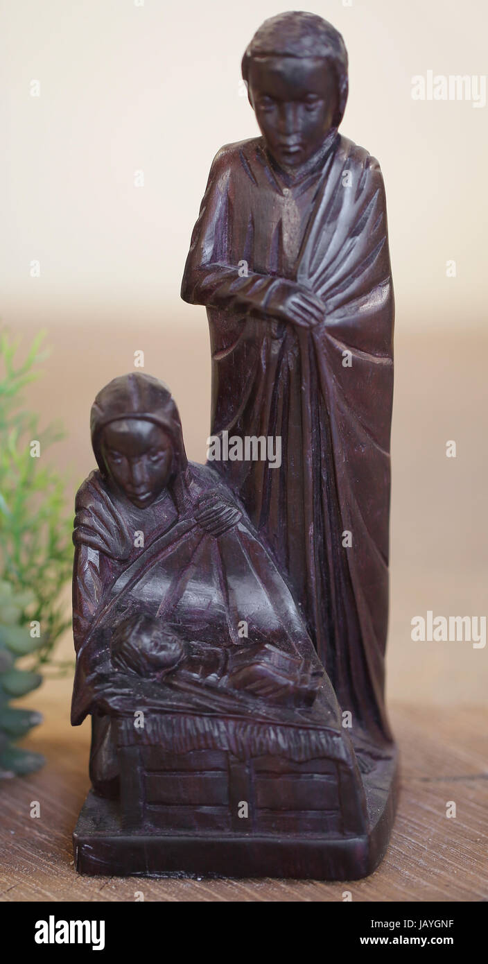 Madagascar Nativity Scene with statues in dark wood inlaid of Holy Family Stock Photo