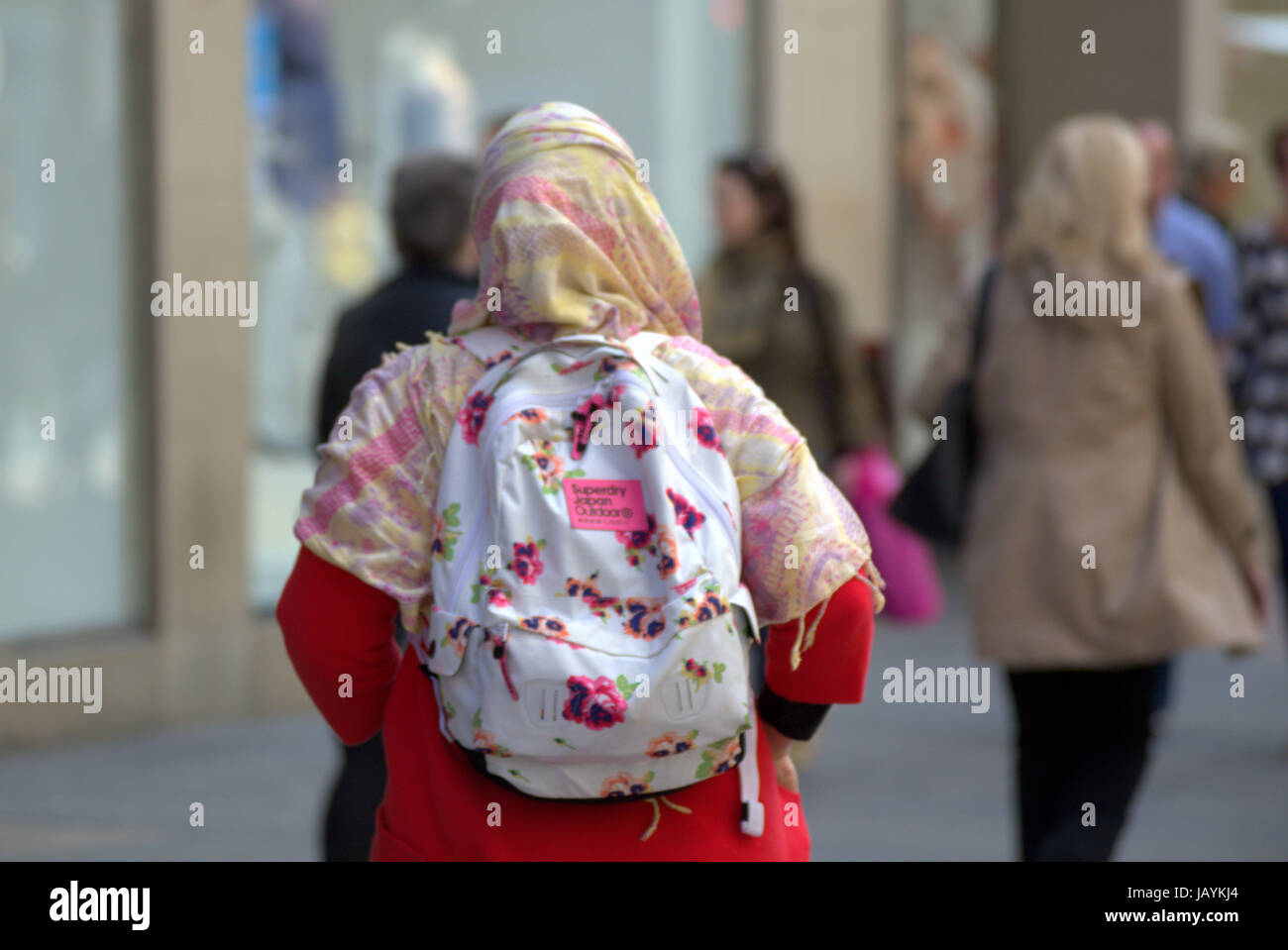young muslim woman wearing hijab scarf walking alone in the city Stock Photo