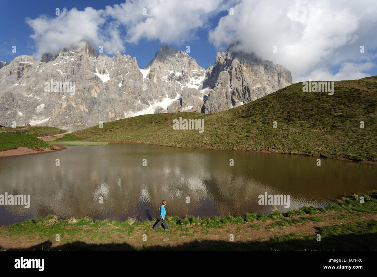 Young boy standing by the lake at baita Segantini, Dolomites, Italy. Stock Photo
