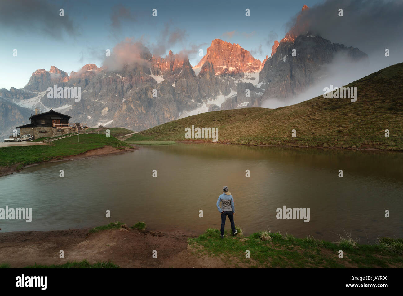 Woman standing by the lake at Baita Segantini, Dolomites, Italy. Stock Photo