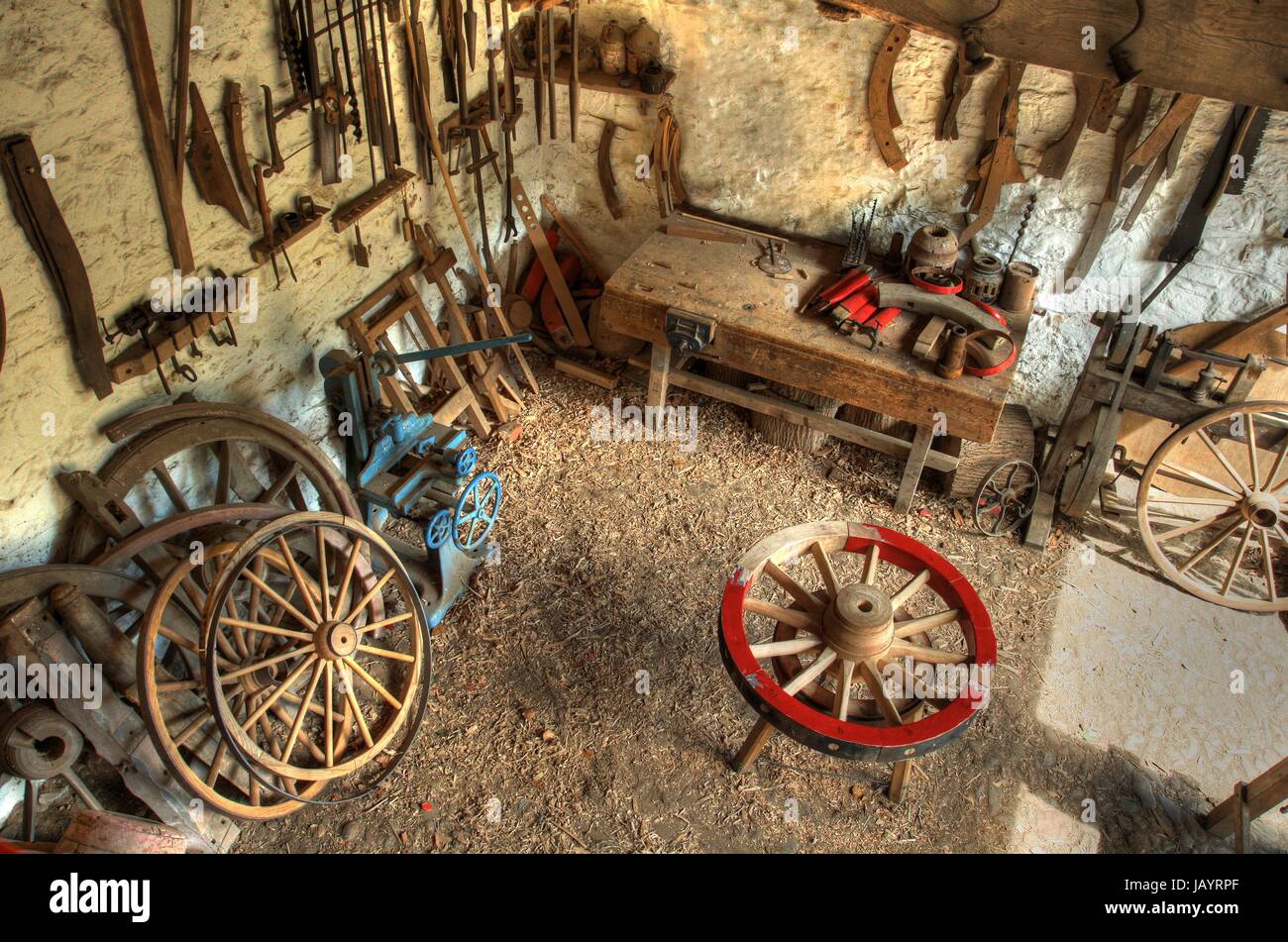 Traditional wheelwrights workshop with tools and cartwheels, England. Stock Photo