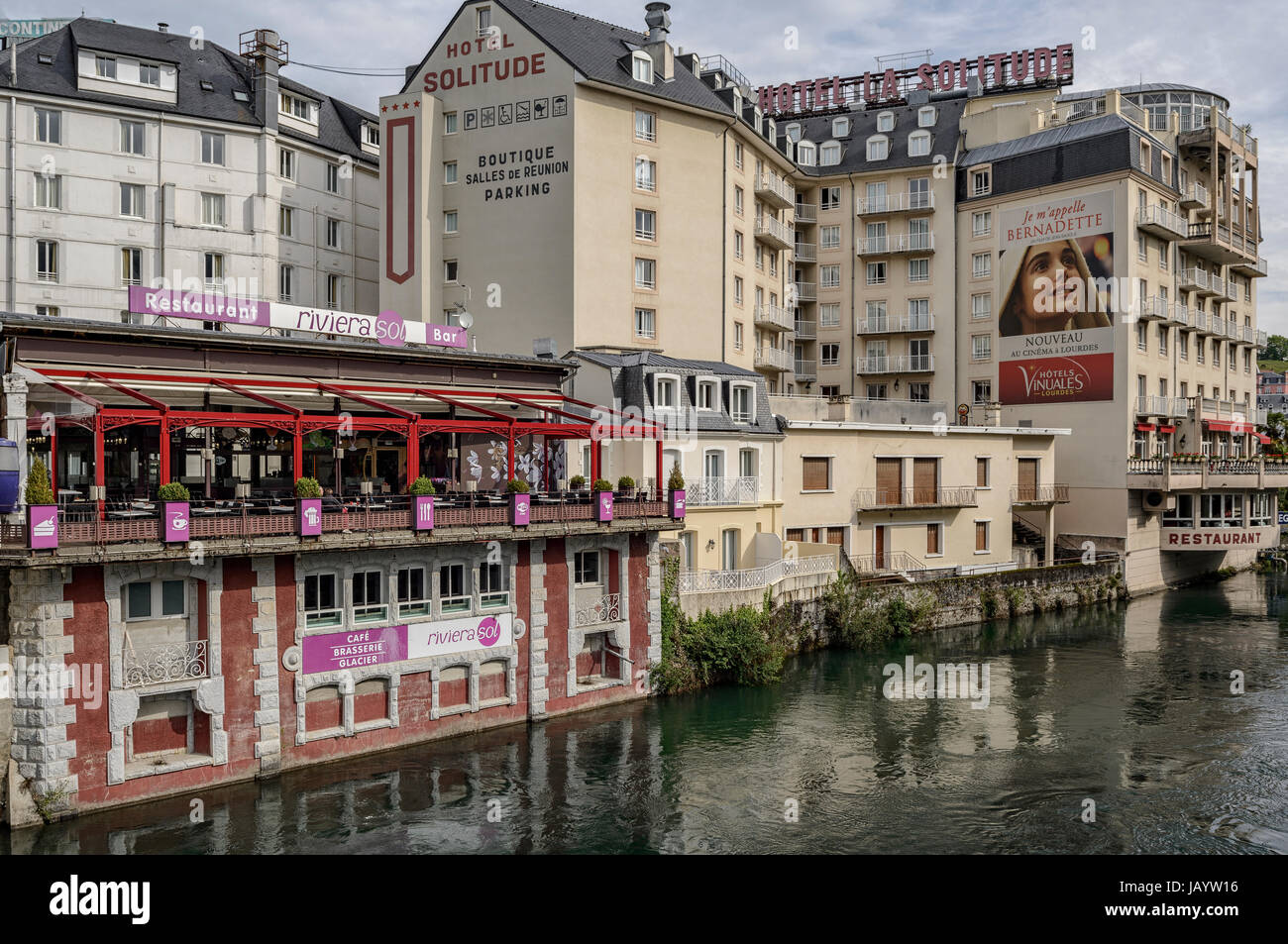 River Gave de Pau in Lourdes with Bernadette poster, Hautes Pyrenees, France Stock Photo