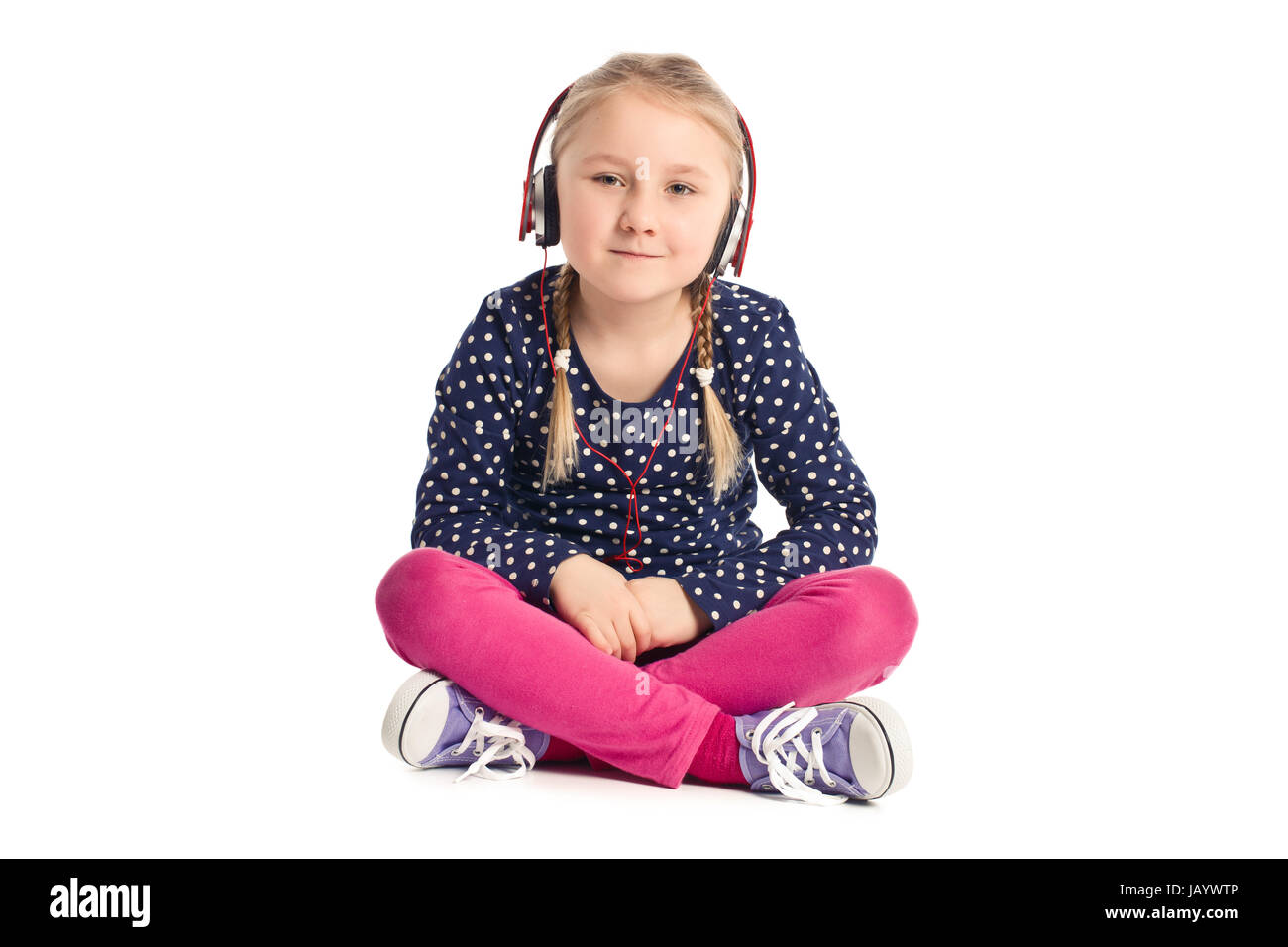 little sitting girl with headphones on white background Stock Photo - Alamy