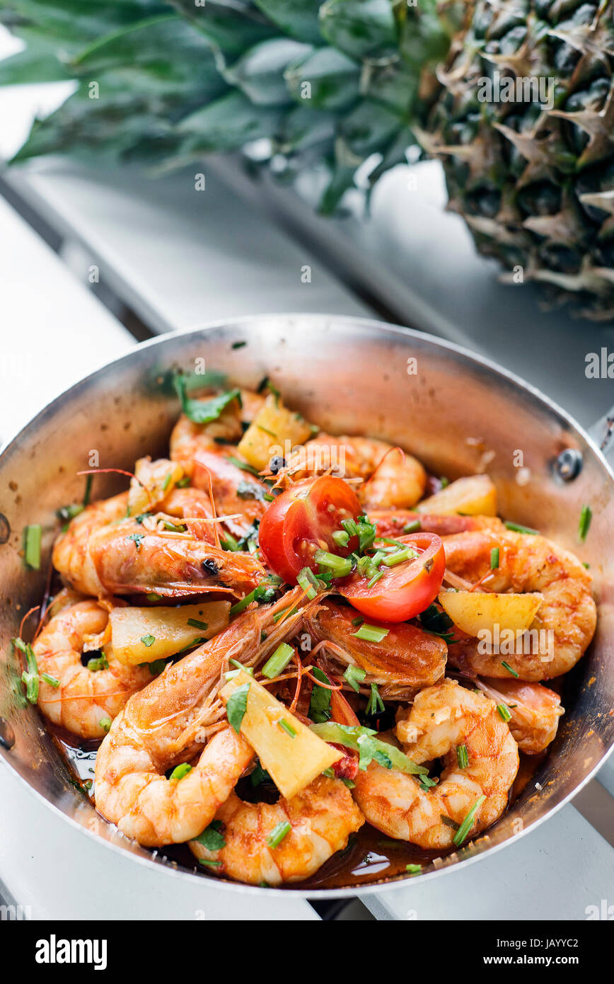 stir fry prawns in spicy asian food pineapple and herbs sauce Stock