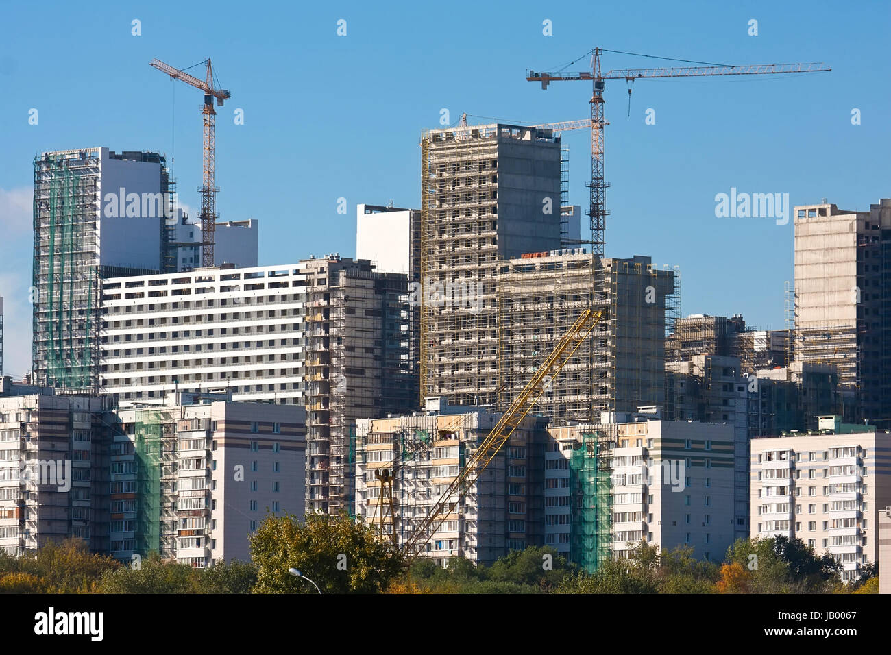 Construction of modern apartment buildings under blue sky Stock Photo ...