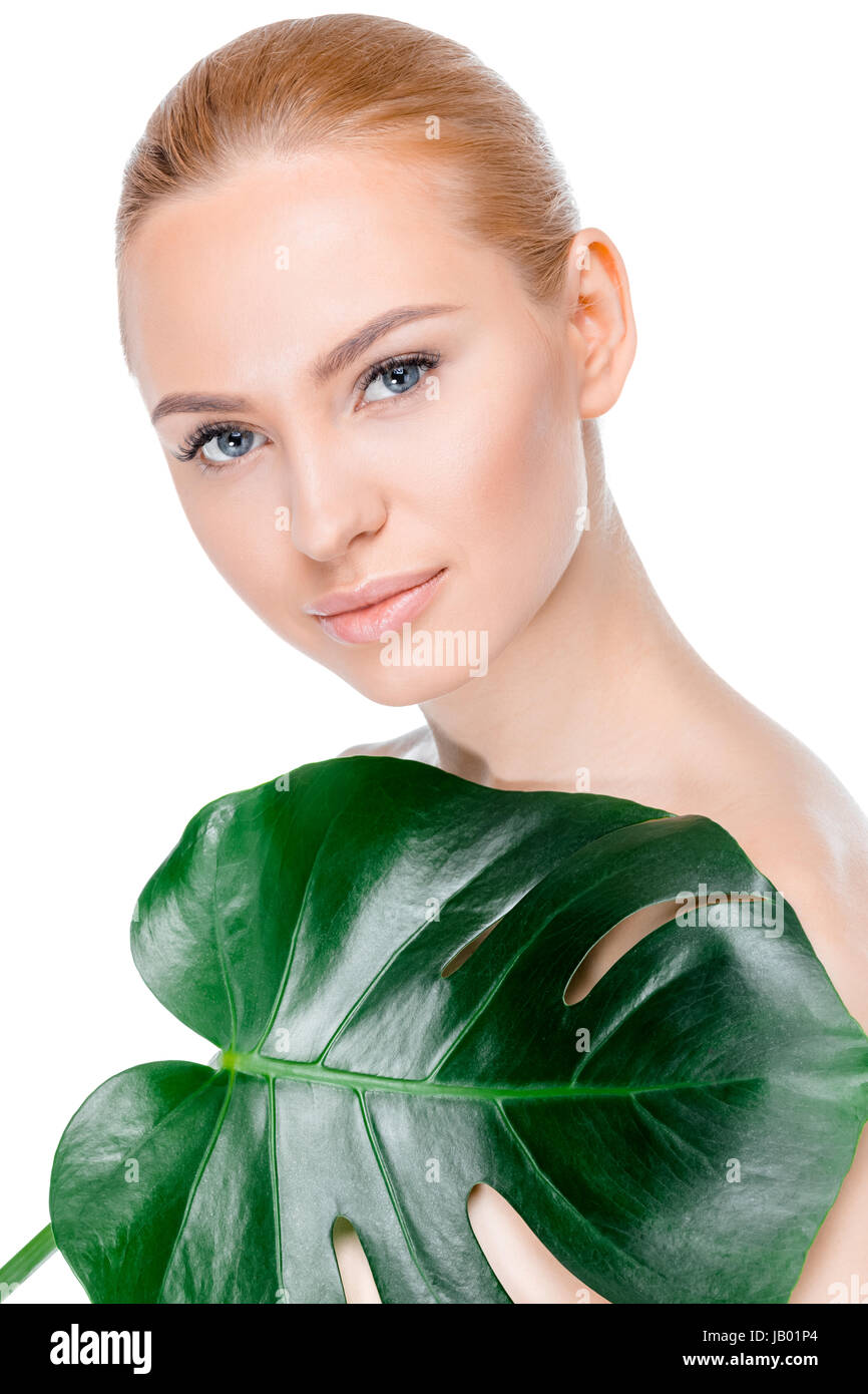 portrait of woman with leaf looking to camera on white Stock Photo