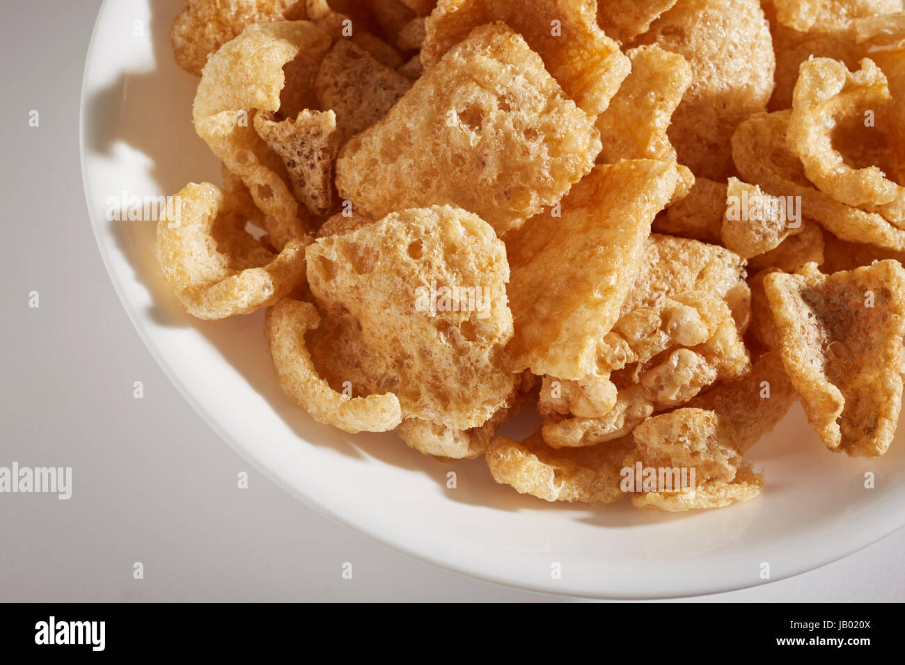 a bowl of fried pork skins Stock Photo Alamy