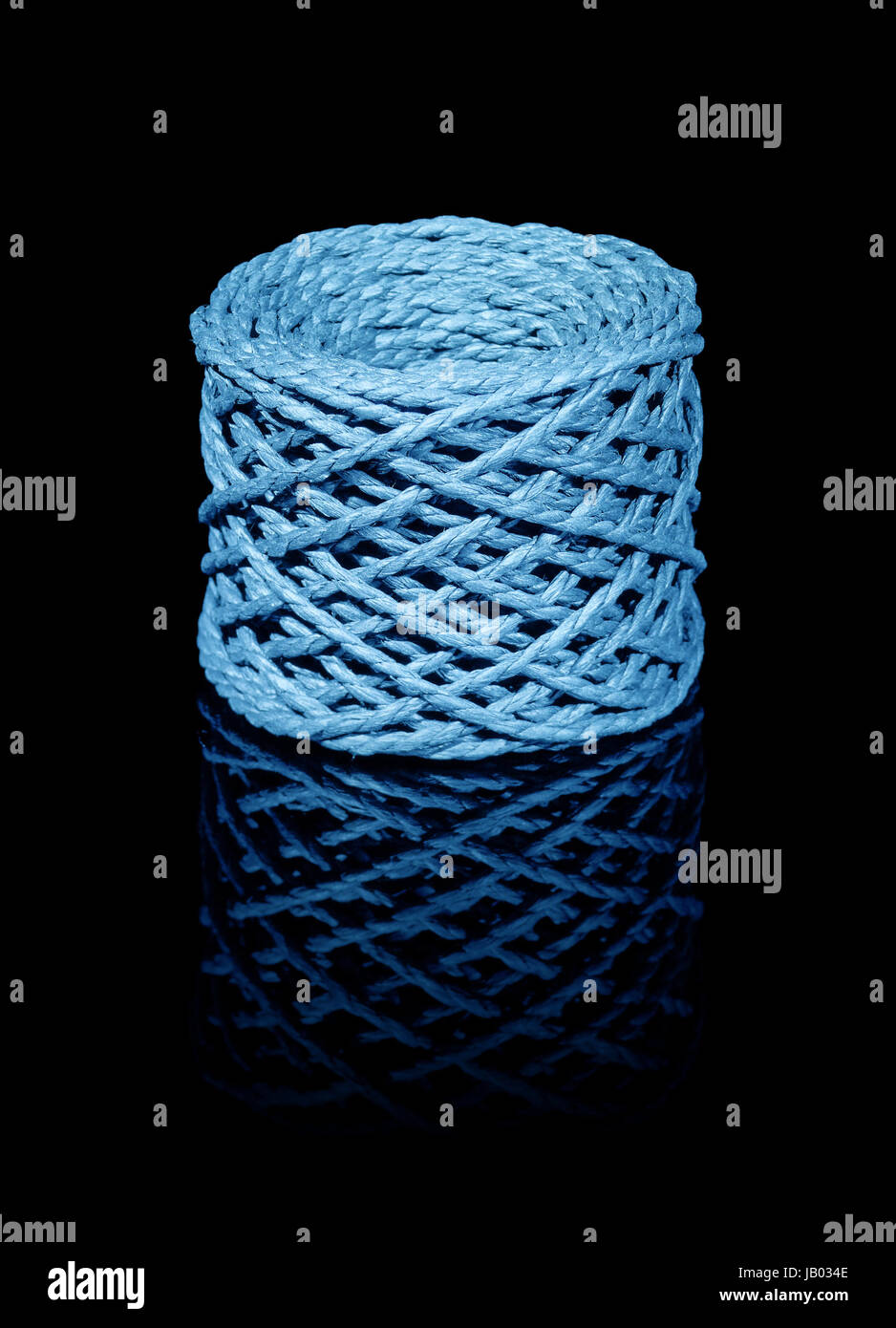 a blue string coil in black reflective back Stock Photo - Alamy