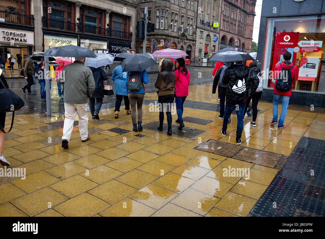 Shoppers in the rain on Princess street Edinburgh Stock Photo Alamy