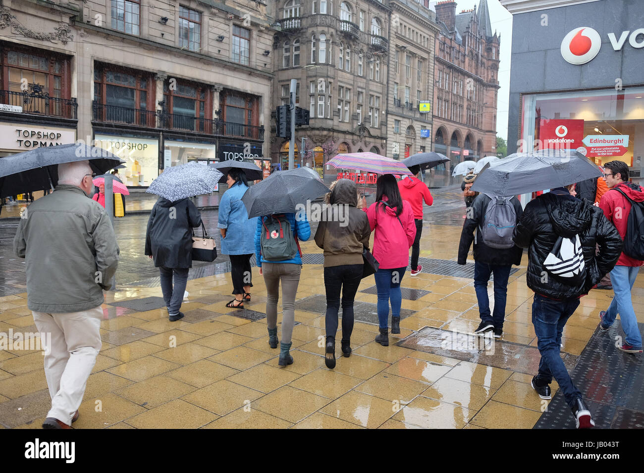 Shoppers in the rain on Princess street Edinburgh Stock Photo Alamy