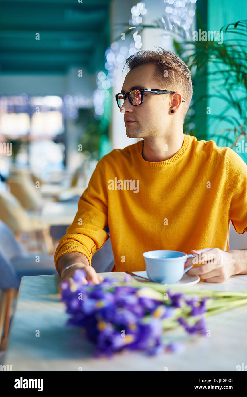 Romantic Guy Waiting for Date in Cafe Stock Photo
