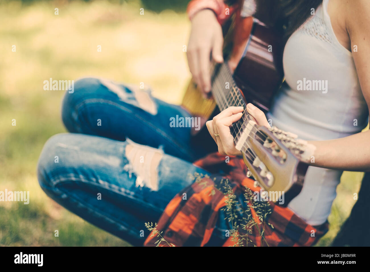 Festival woman with guitar at party Stock Photo