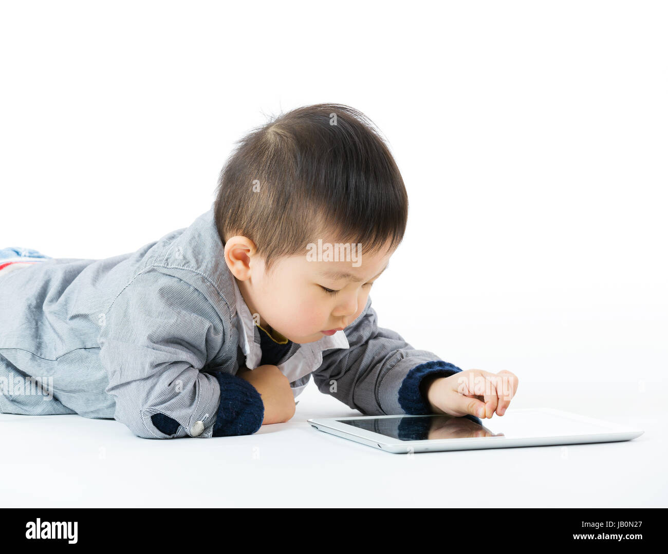Asian little boy using tablet Stock Photo - Alamy