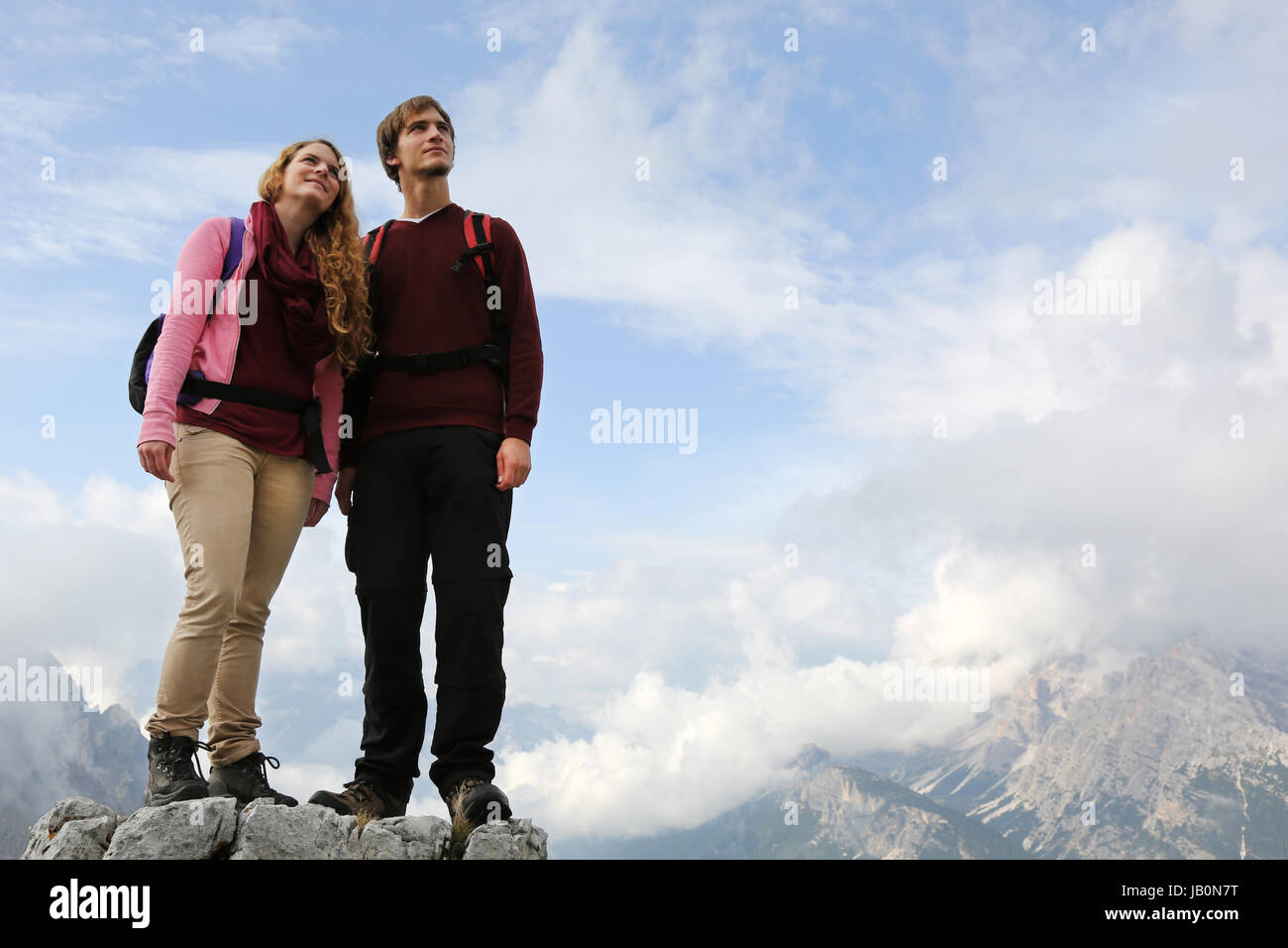 Junge Bergsteiger stehen auf einem Berggipfel und genießen die Freiheit und ihren Erfolg Stock Photo