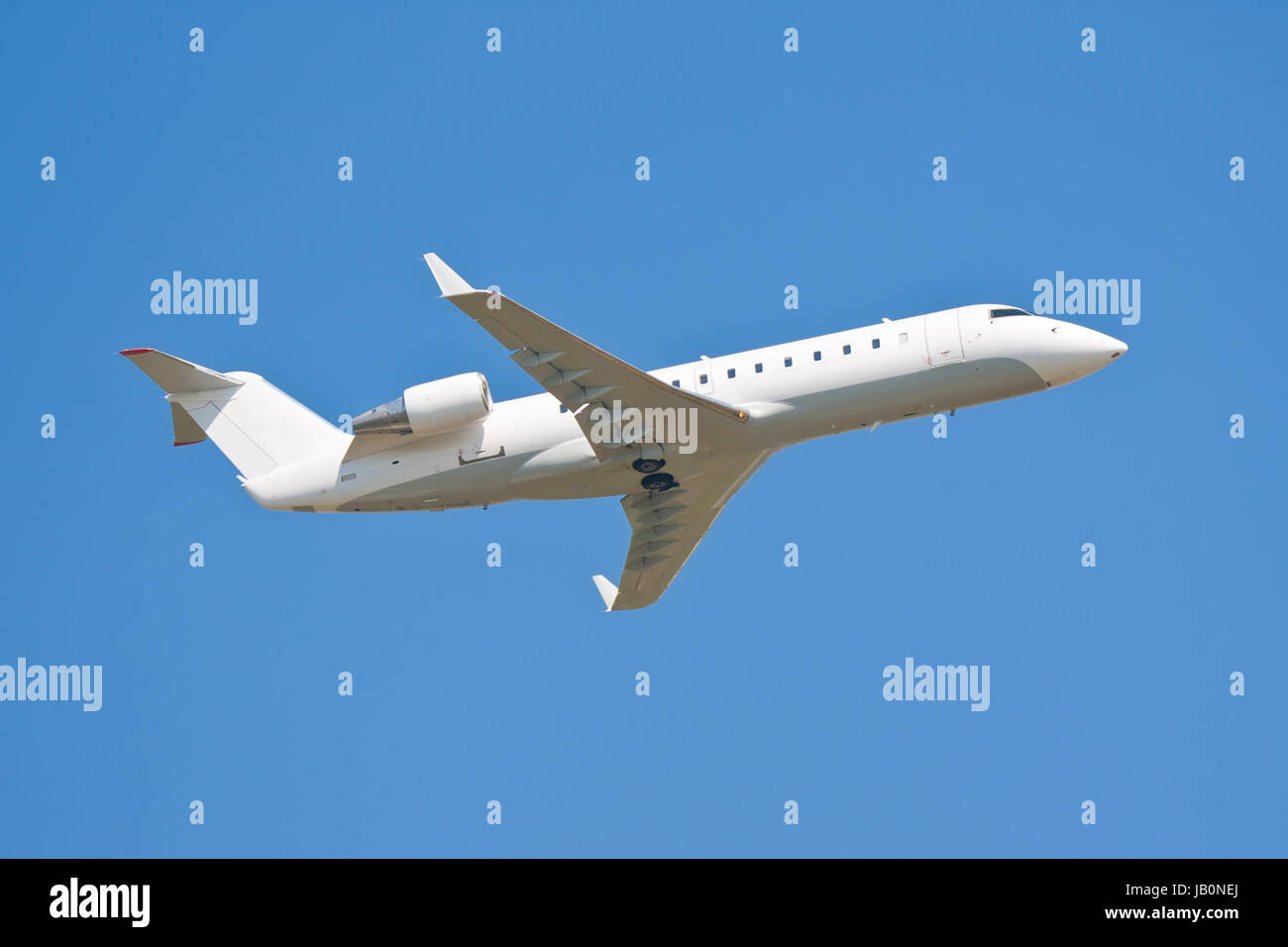 Beautiful white passenger airplane in blue sky Stock Photo - Alamy