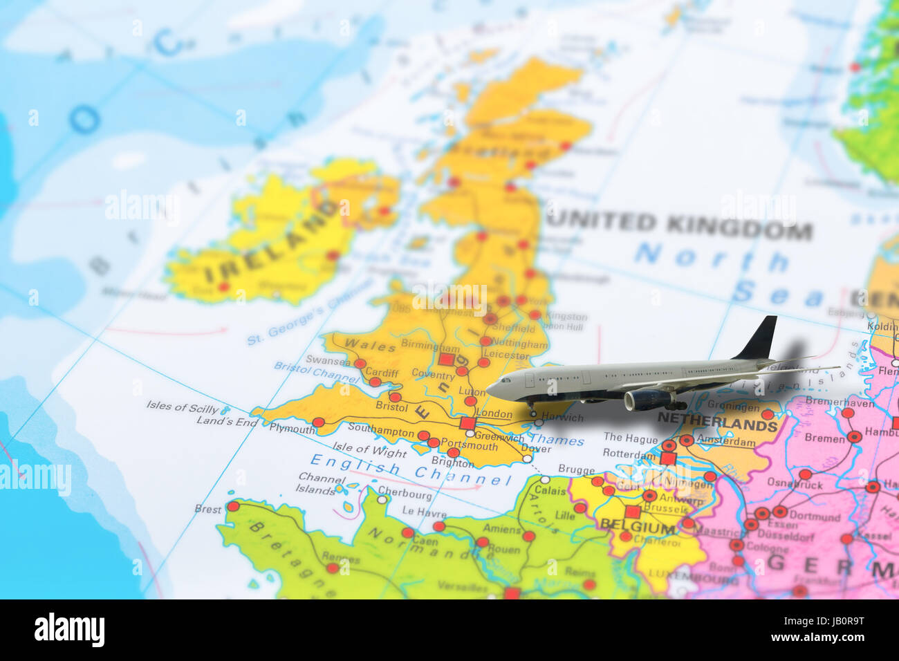 United Kingdom map with flight of airplane travelling on colorful political map to London. Geopolitical school atlas. Holidays and travel concept. Fli Stock Photo