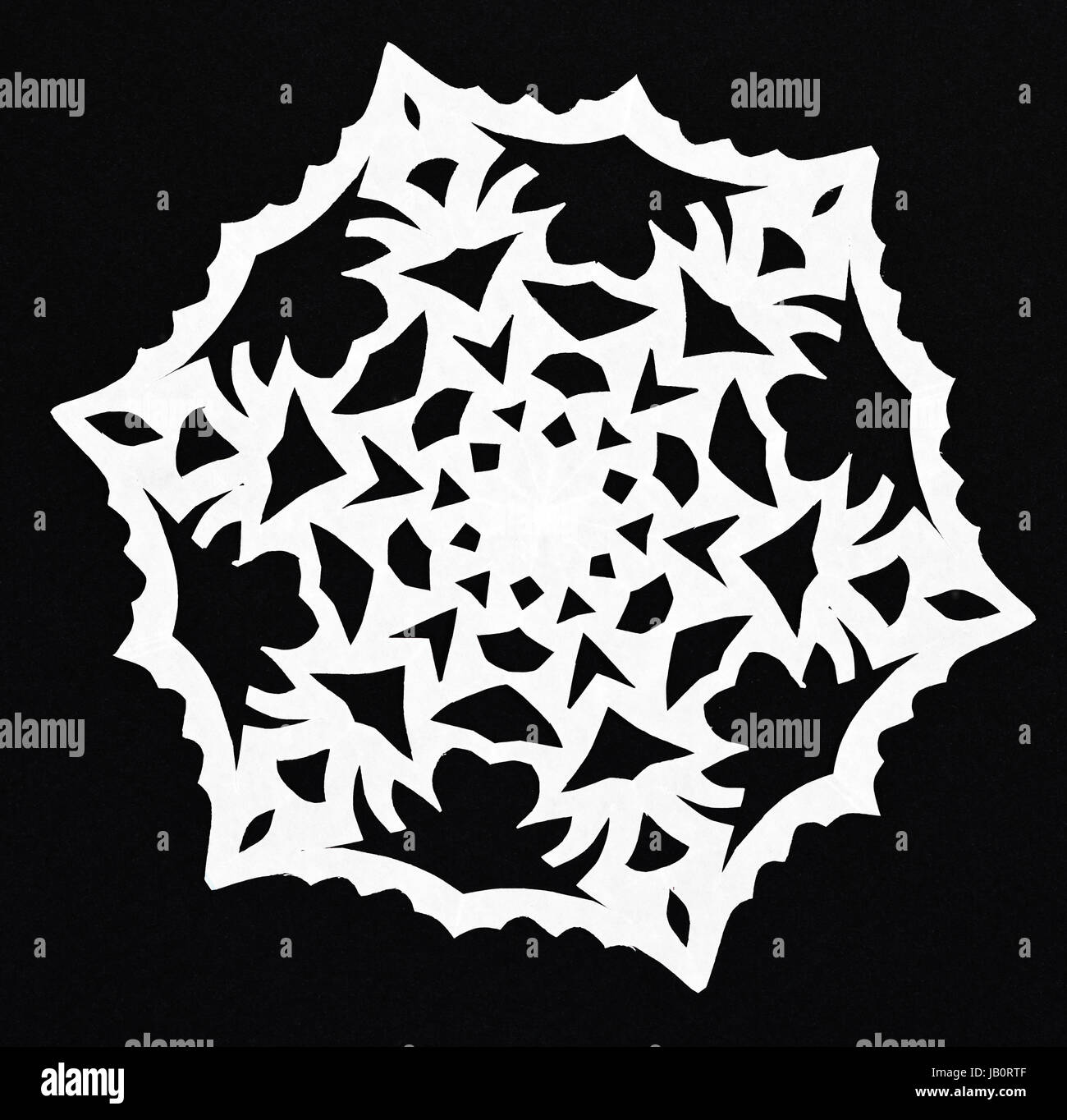 hand made cut out white snowflake on black paper background Stock Photo ...