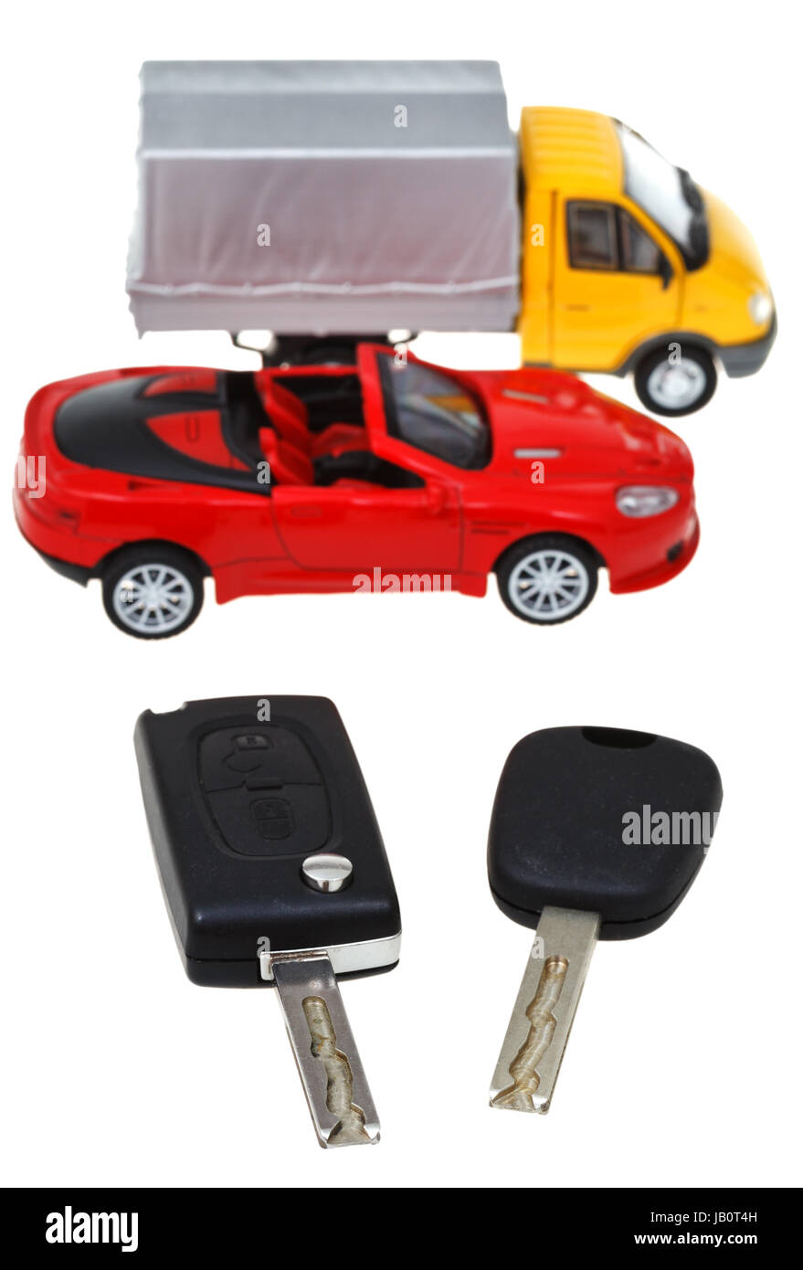 two vehicle keys and model truck and car isolated on white background ...