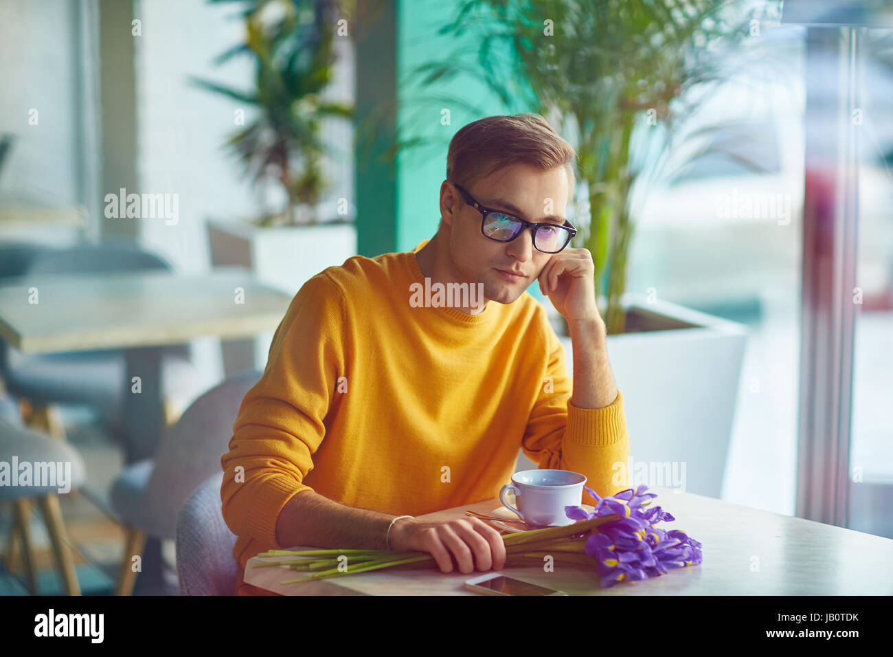 Bored Guy Waiting for Girlfriend in Cafe Stock Photo