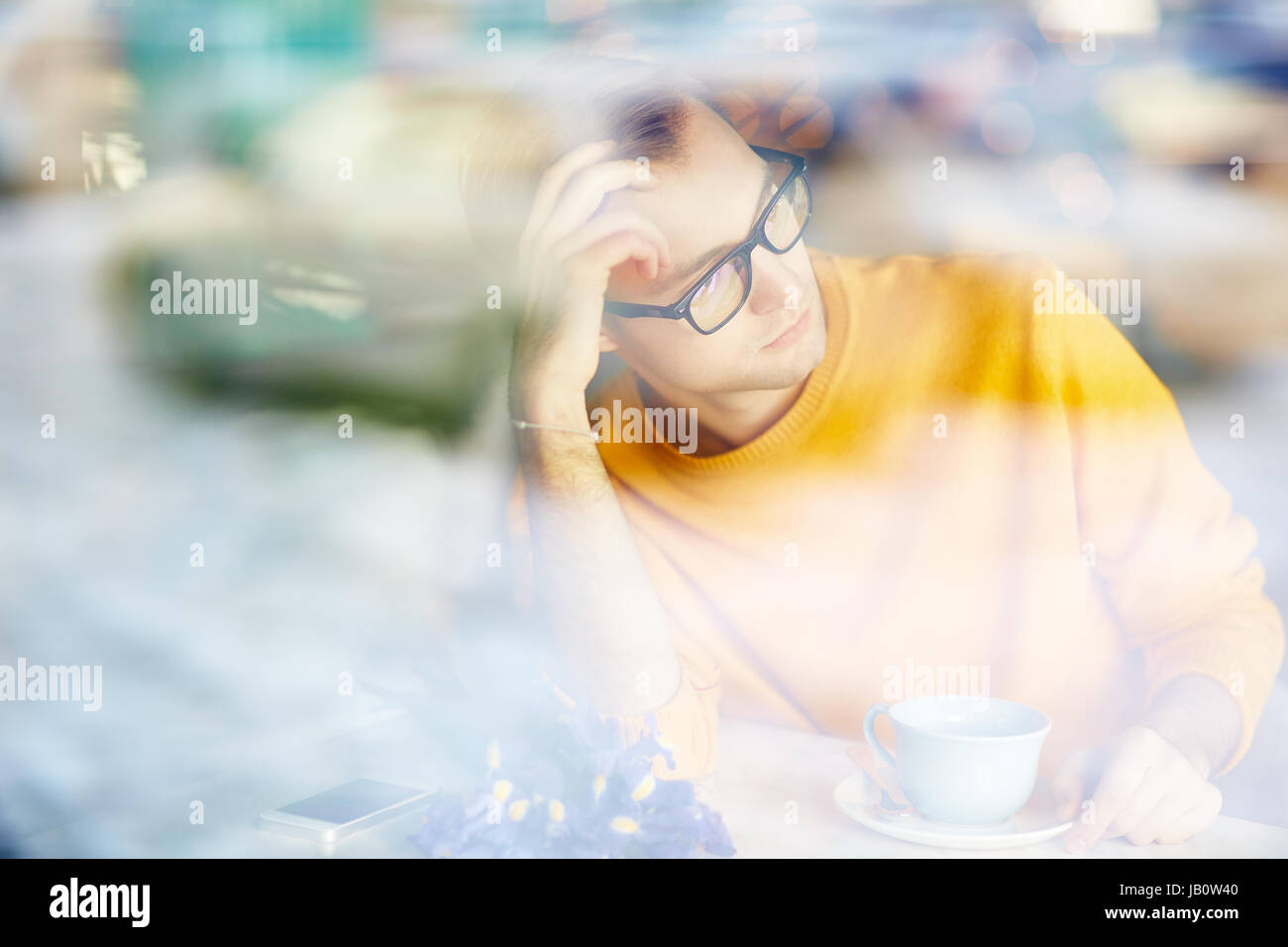 Pensive Man Waiting for Date in Cafe Stock Photo