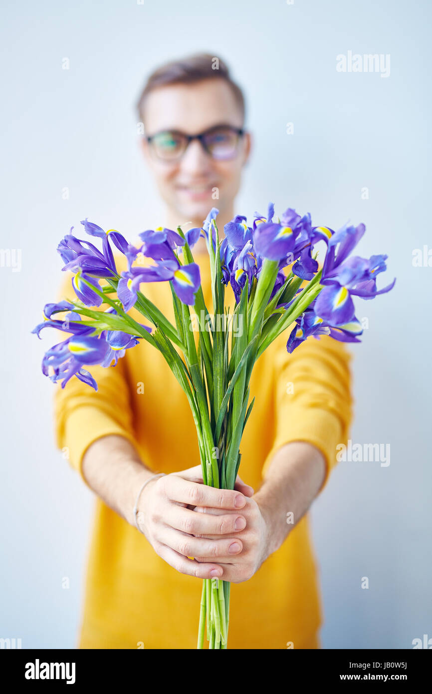 Young Valentine Presenting Irises Stock Photo