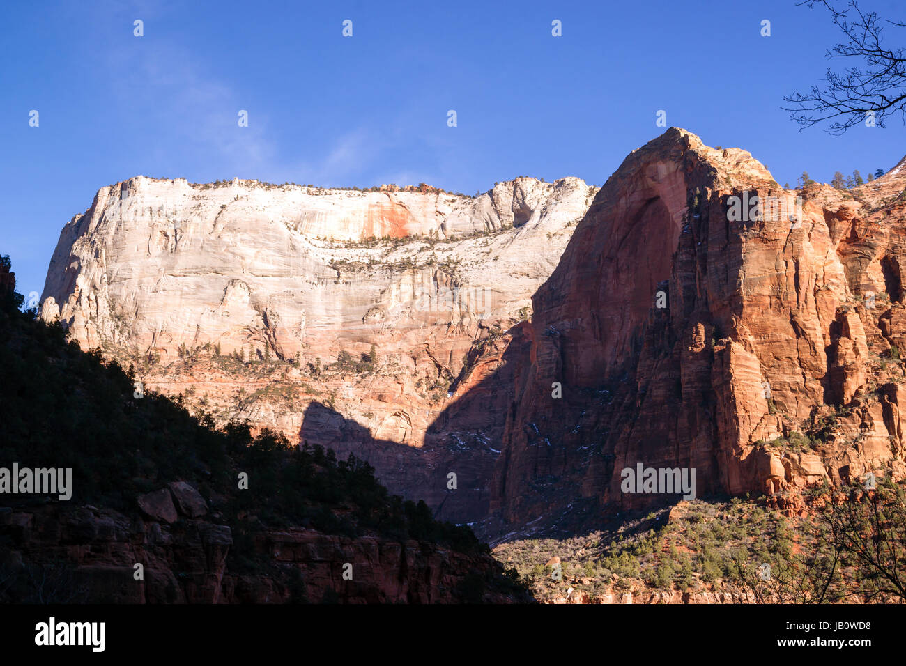 The light has not quite reached the valley int this horizontal composition of early morning in the desert Southwest Stock Photo