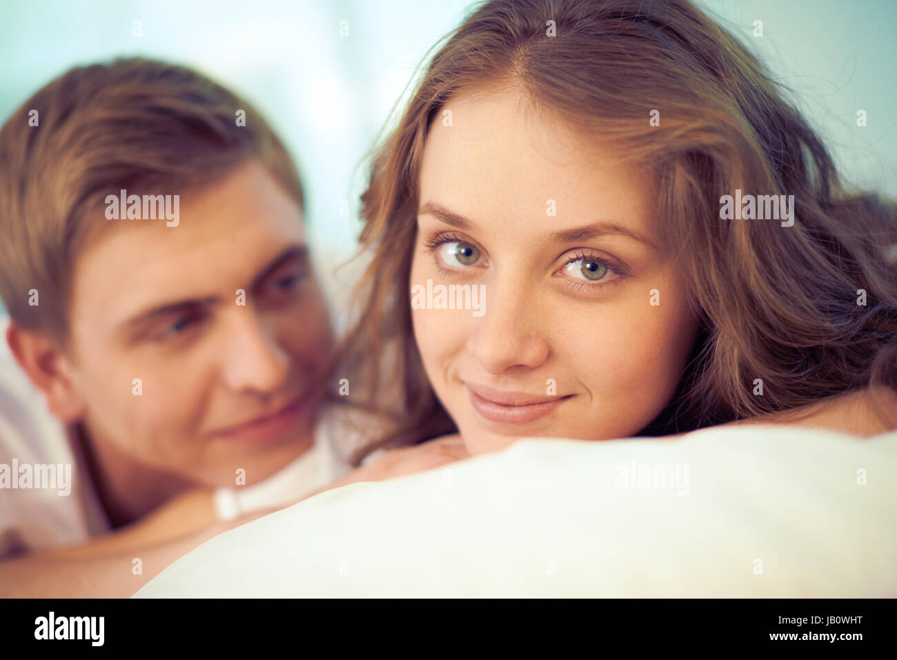 Portrait of pretty young female looking at camera with smile and her ...