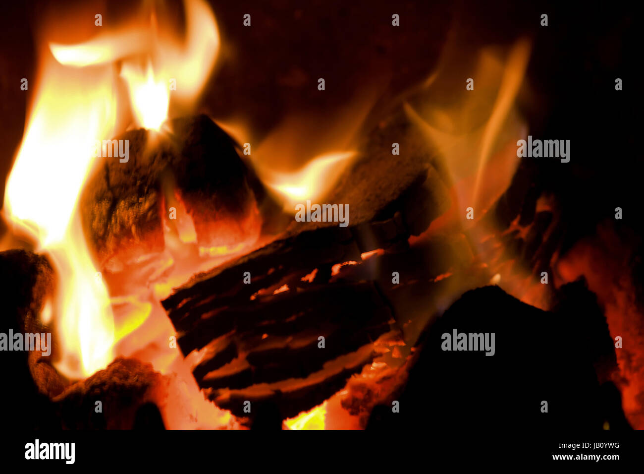 peat briquettes burning in a red hot fire Stock Photo