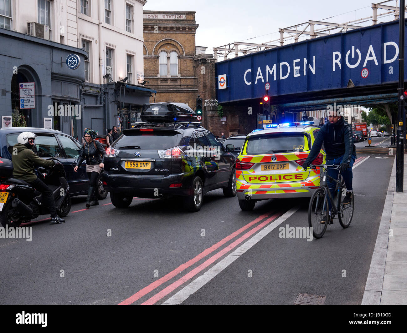 Police car has to drive on a separated cycle lane on an emergency call Royal College Street Camden Town London UK Stock Photo