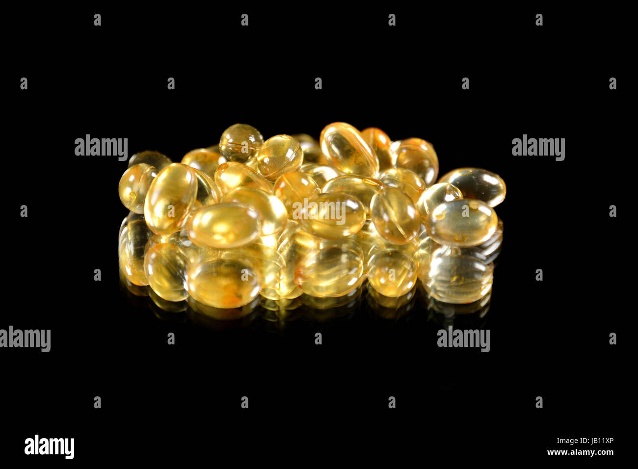 Capsules (pills) isolated on black and mirror background Stock Photo