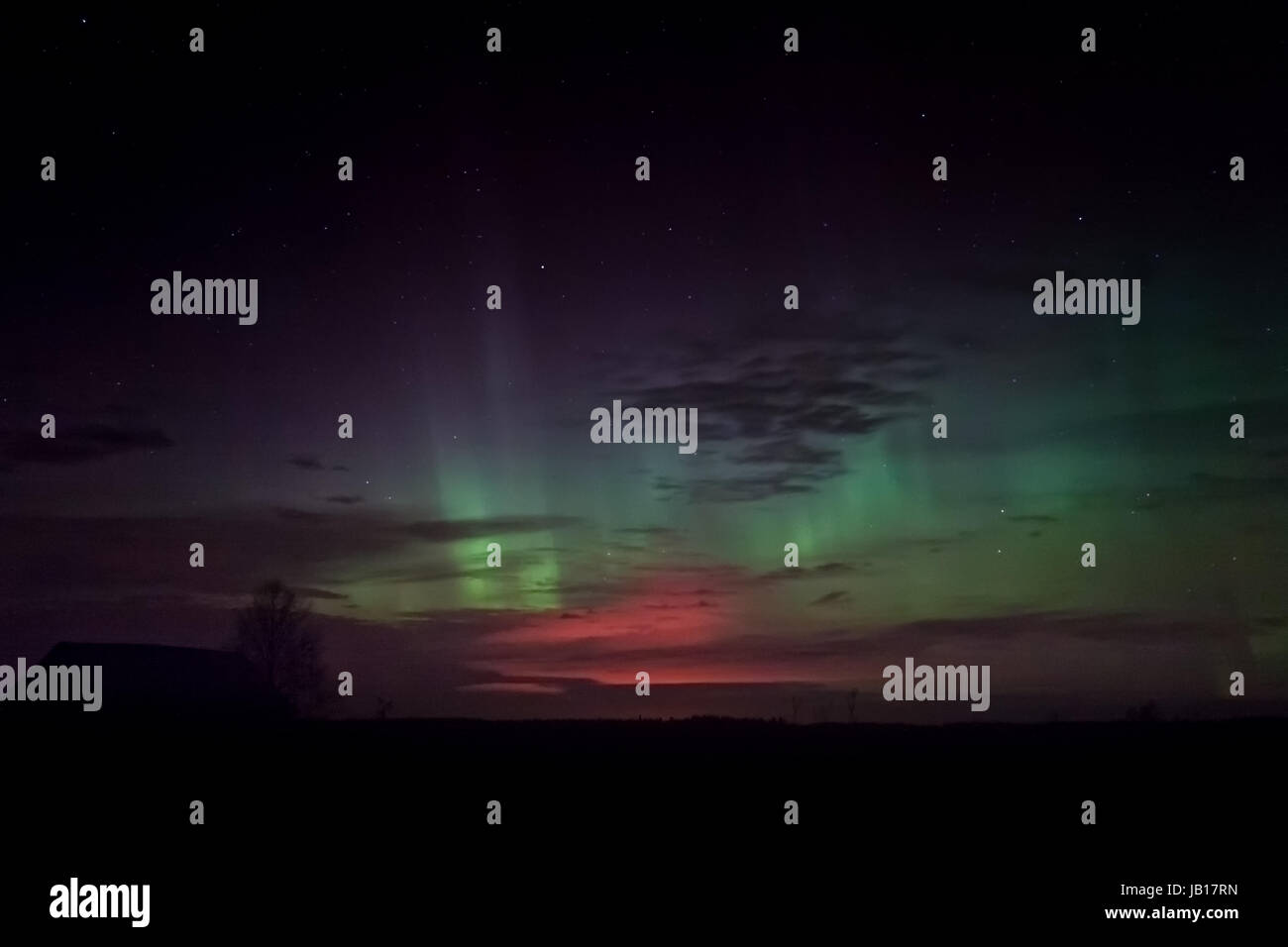 Beautiful aurora borealis over an old barn house at the Norhtern ...