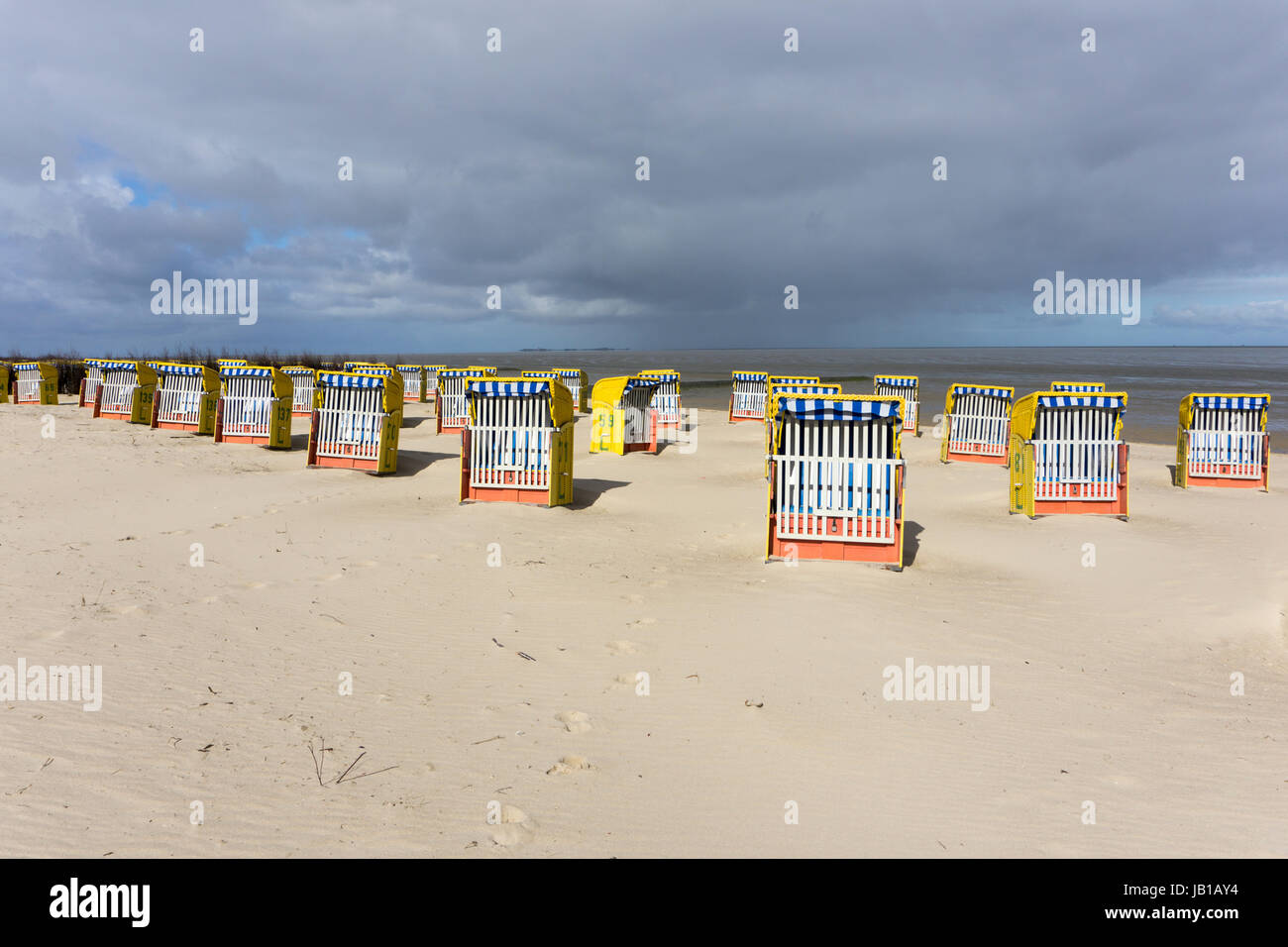 Dark clouds over the North Sea, beach chairs on sandy beach, Cuxhaven ...