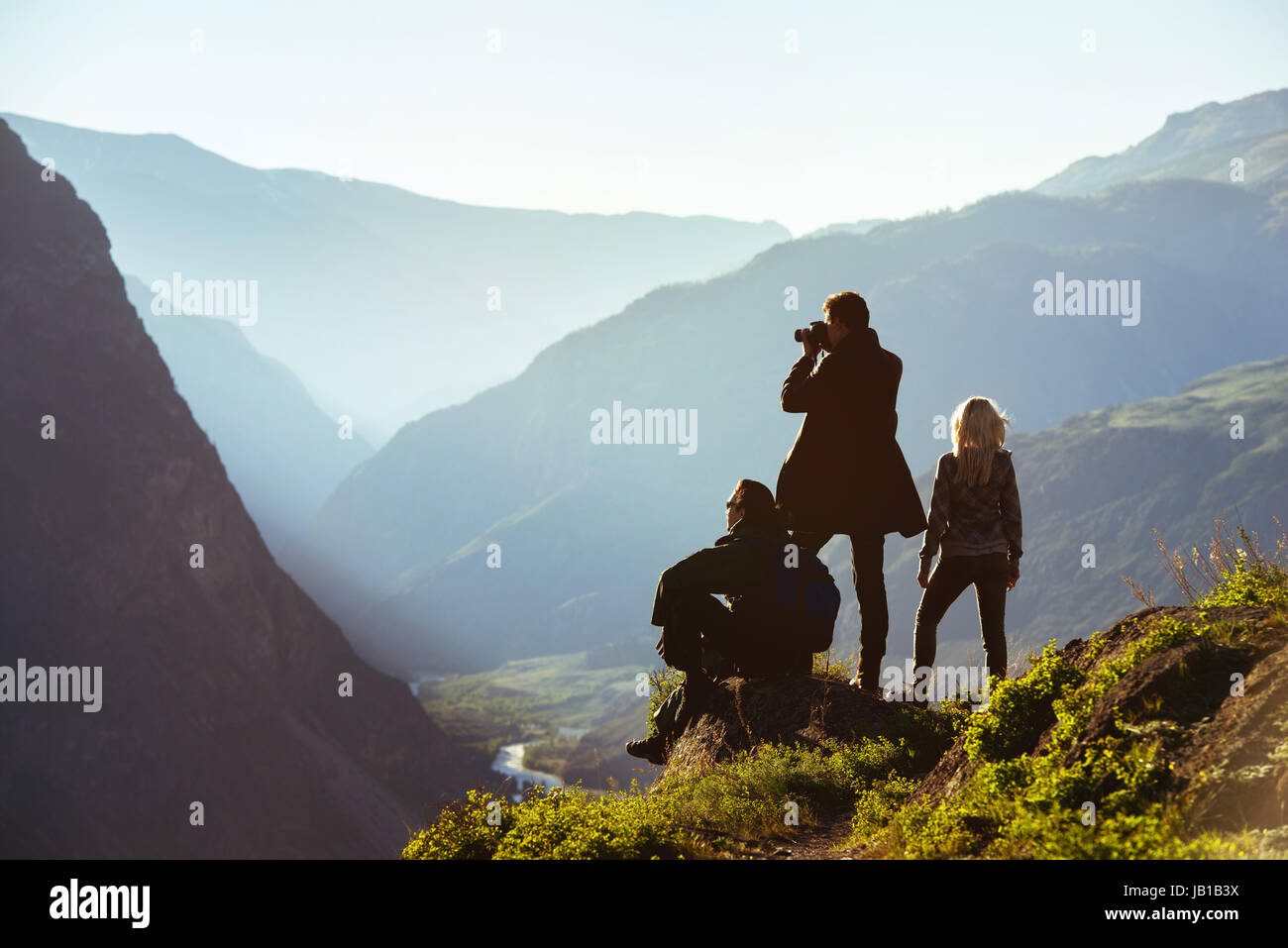 Group of three friends in mountains range Stock Photo