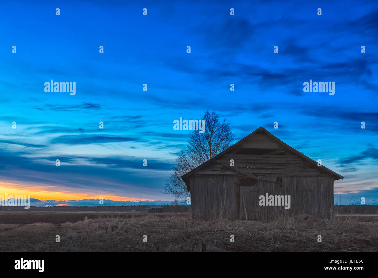 Old barn house under the dramatic springtime night sky in the rural ...
