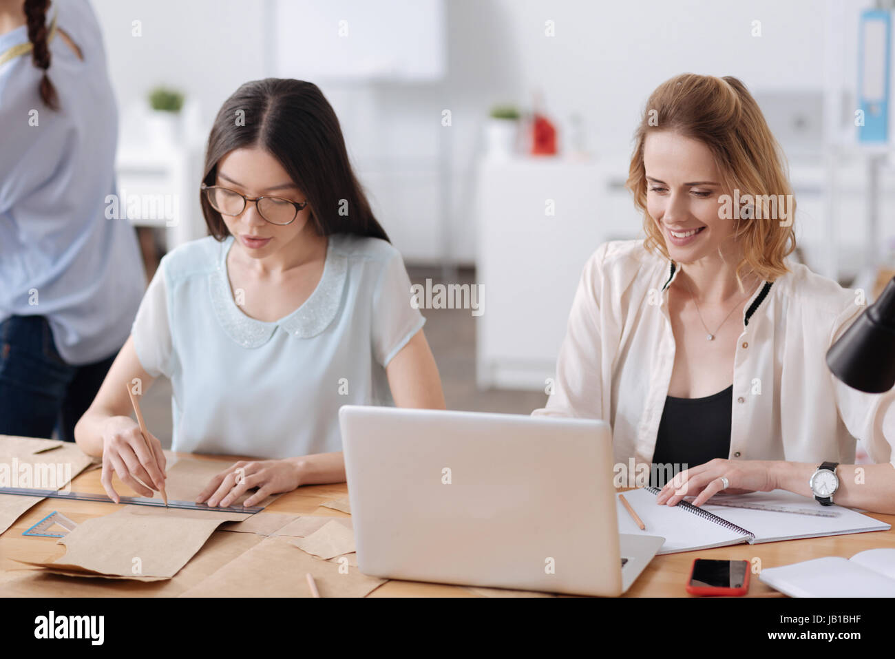 Pretty young women being immersed in work Stock Photo
