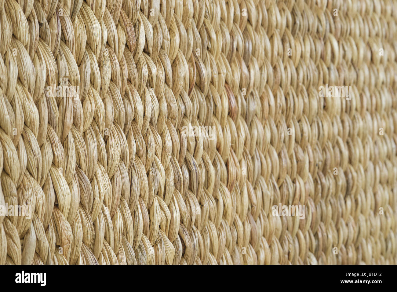 Meshwork of wooden reed wicker texture background. Oblique view Stock Photo