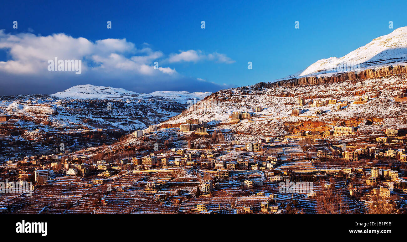 Beautiful landscape of mountainous town in winter, many cozy cottage, eco tourism, Faraya mountain in Lebanon, ski resort, wintertime holidays concept Stock Photo
