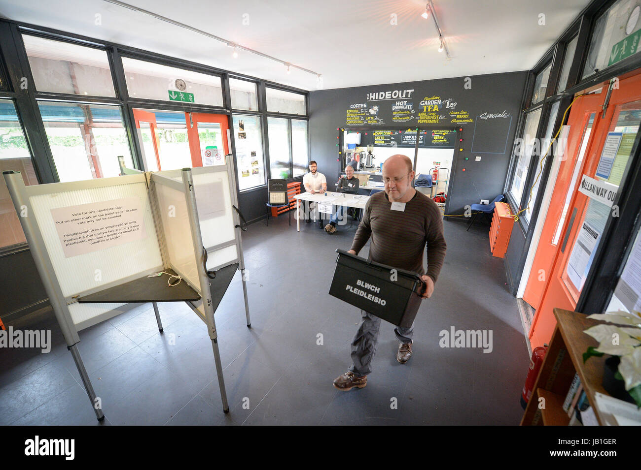 A Welsh 'Blwch Pleidleisio' or 'Ballot Box' is carried inside the Grange Pavilion bowling club, which is a polling station in Grangetown, Cardiff, as voters head to the polls across the UK to vote in the General Election. Stock Photo